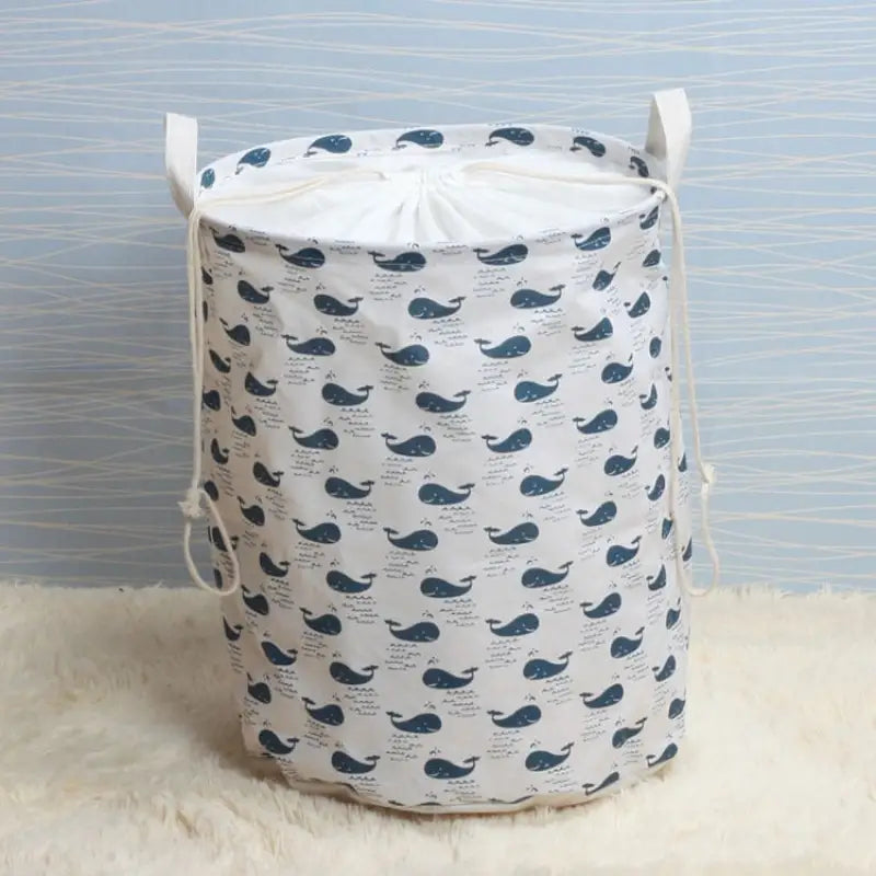 a blue whale print laundry bag on a white rug