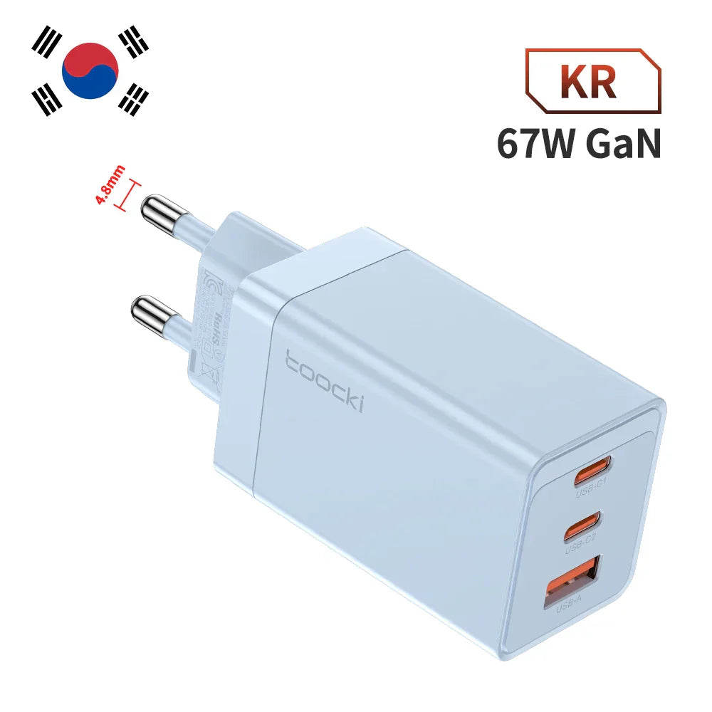 White 67W GaN charger with three USB ports and a South Korean plug.