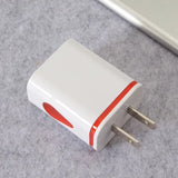 a white and red usb charger on a gray surface