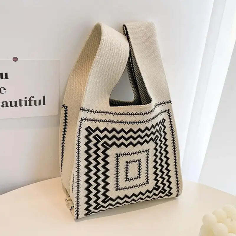 a white bag with black and white geometric pattern