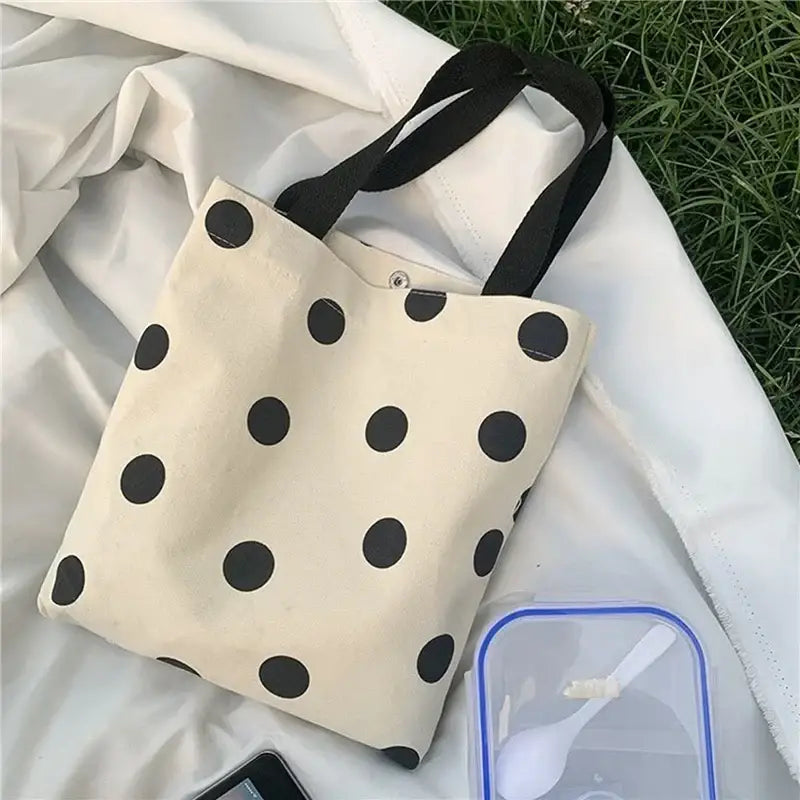 a white bag with black polka dots on it