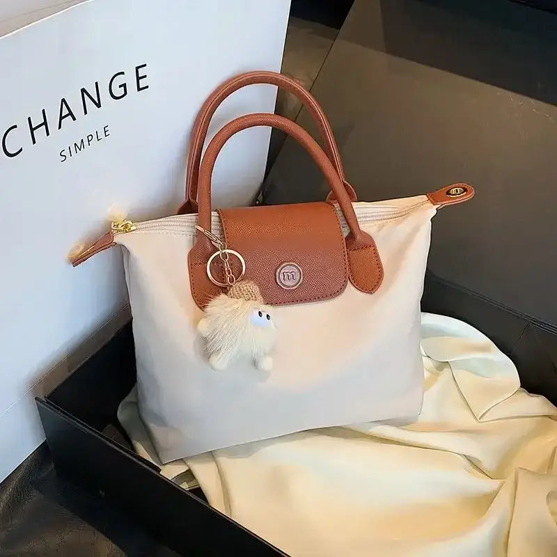 there is a white bag with a brown handle and a white bag with a brown handle