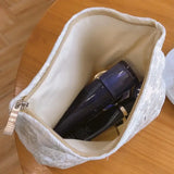 a white bag with a cell inside