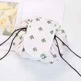 a white bag with a green cactus print on it