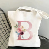 a white bag with a pink flower on it