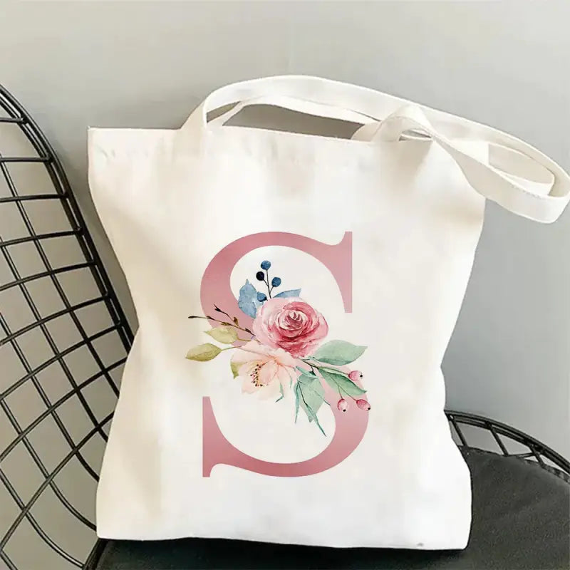 a white bag with a pink flower on it
