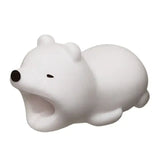 a white bear toy laying on top of a white surface