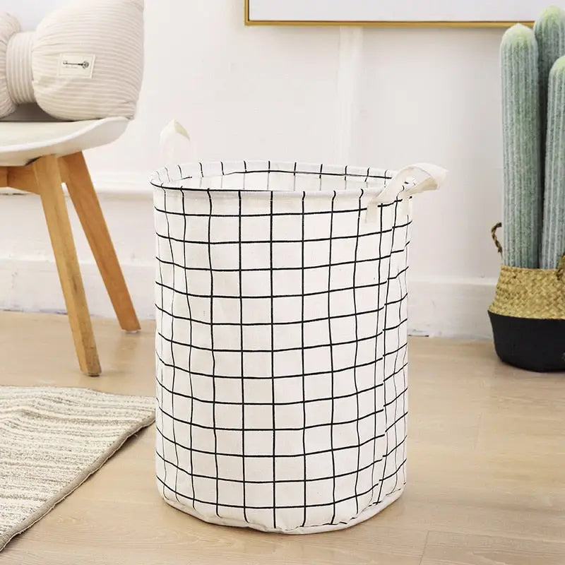 a white and black basket on the floor
