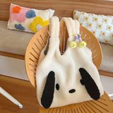 a white and black bunny bag with a wooden handle