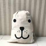 a white bag with a black face on it
