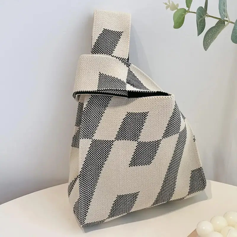 a white and black geometric pattern bag on a table