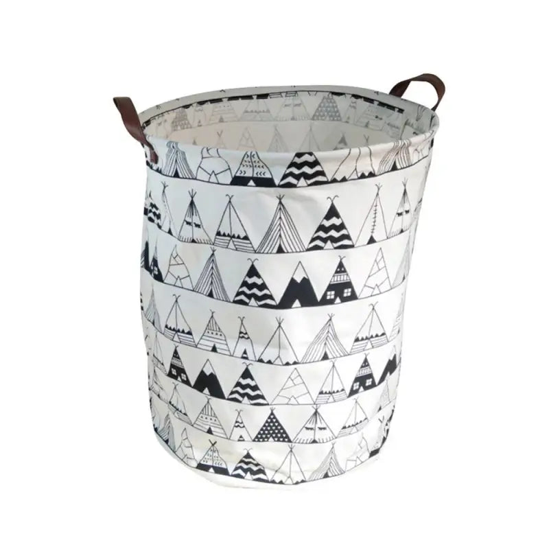 a white and black patterned fabric basket with a brown leather handle