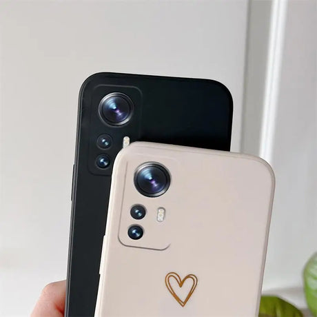 The back of a white and black phone with a heart on it