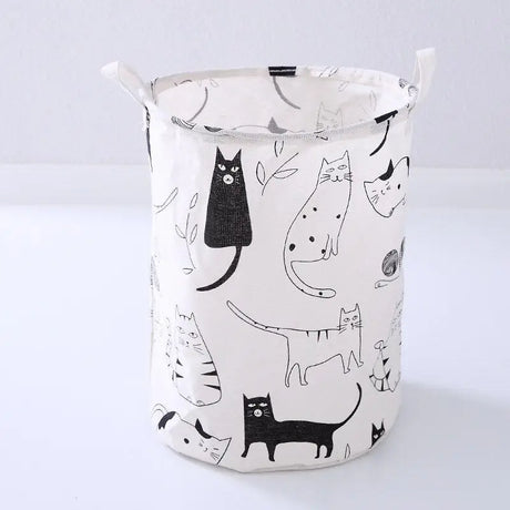 a white and black cat laundry basket with a black cat pattern