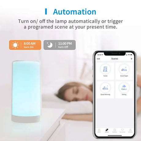 A white and blue alarm clock with a person sleeping on the bed