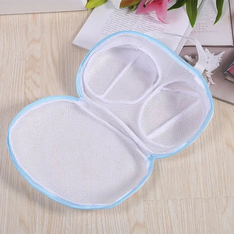 a pair of white and blue eye masks on a wooden table