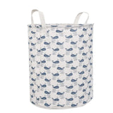 a white and blue whale print laundry basket with handles