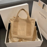 a white box with a beige bag inside