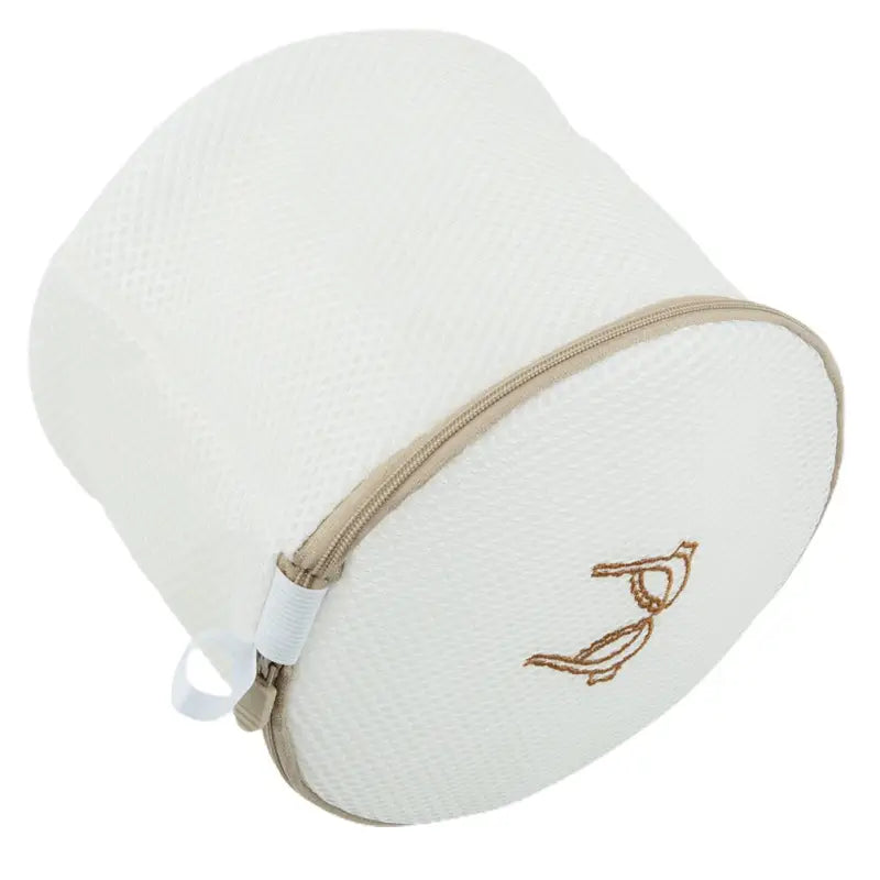 the white and gold travel pillow with a zipper closure