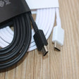 there is a white cable connected to a black and white charger