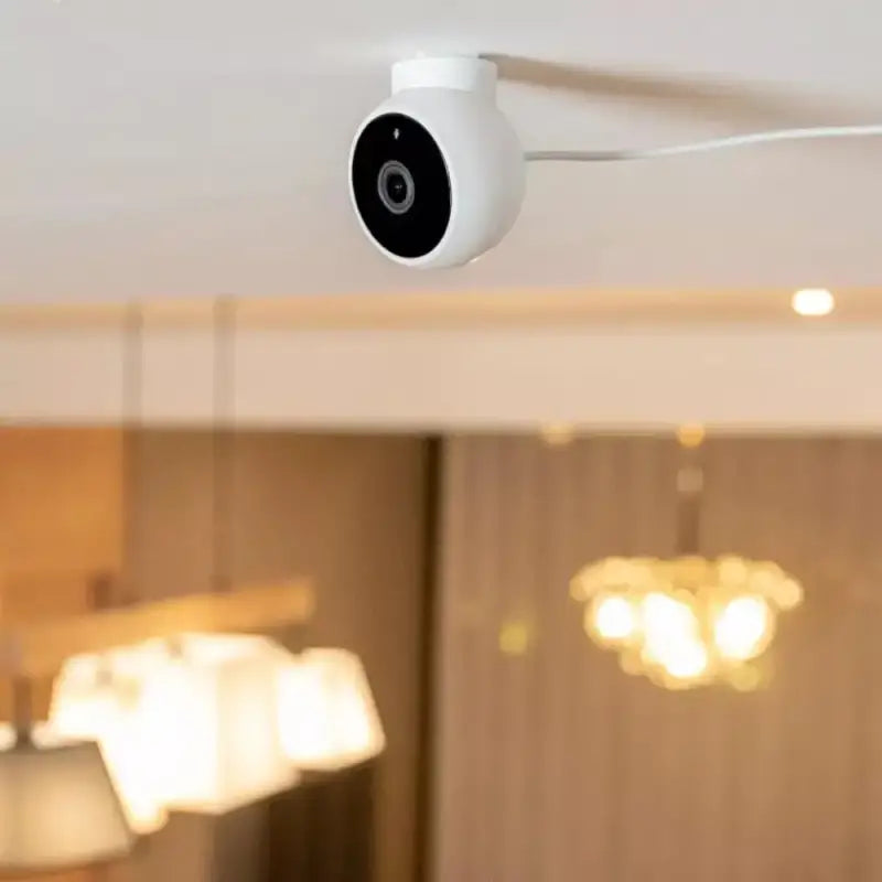 a white camera mounted on the ceiling