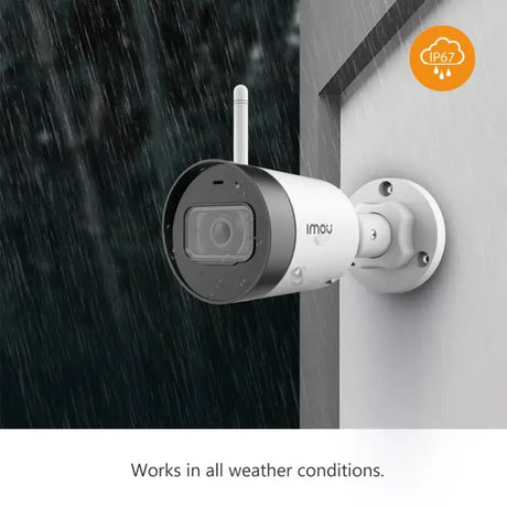 A white camera on a wall with the words work in all weather conditions