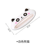 a white cat shaped hair clip with pink eyes