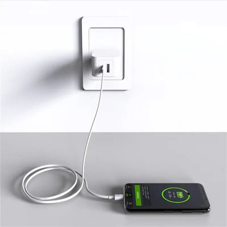 a white wall charger with a green cord