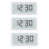 a white clock with three different times