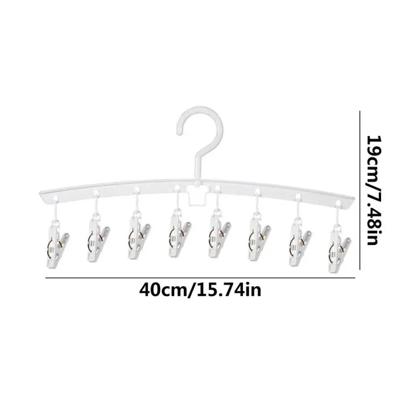 a white coat rack with five hooks and a white hanger