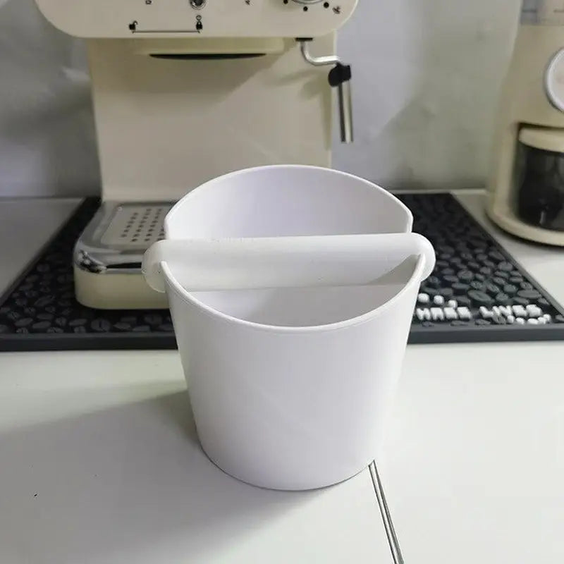 a coffee cup sitting on top of a white table