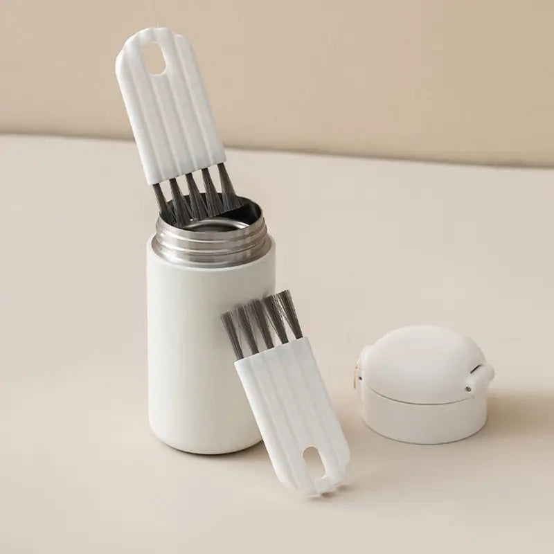 a white container with two forks and a spoon