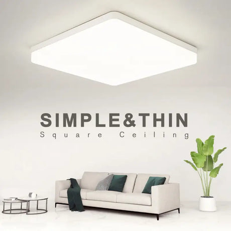 A white couch sitting in front of a white wall