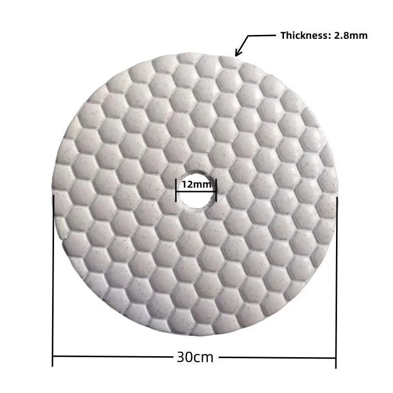 a white circular tile with a pattern of small squares