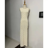 a white dress on a mannequin stand in a room