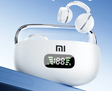 White electronic device with a digital display and a handle, featuring the ’mi’ logo and a pair of headphones resting on top.