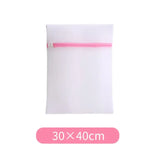 a white envelope with pink ribbon