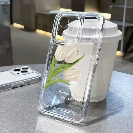 A white flower in a clear case on a table