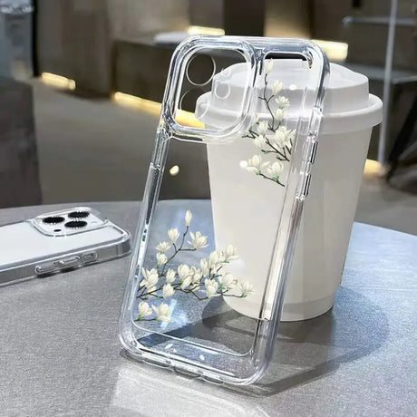 A white flower in a clear case on a table