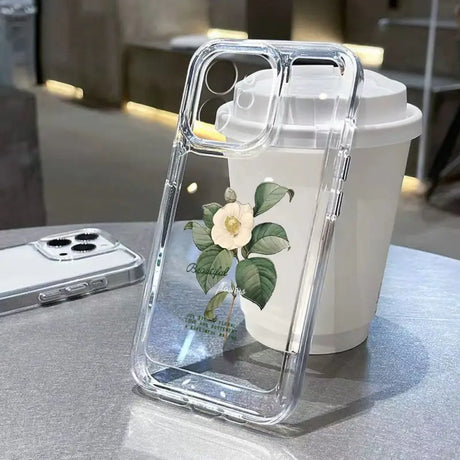 a white flower in a clear case on a table