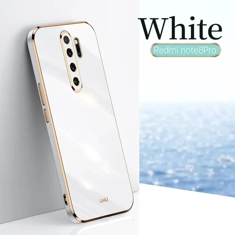 a white and gold phone with the white logo on it