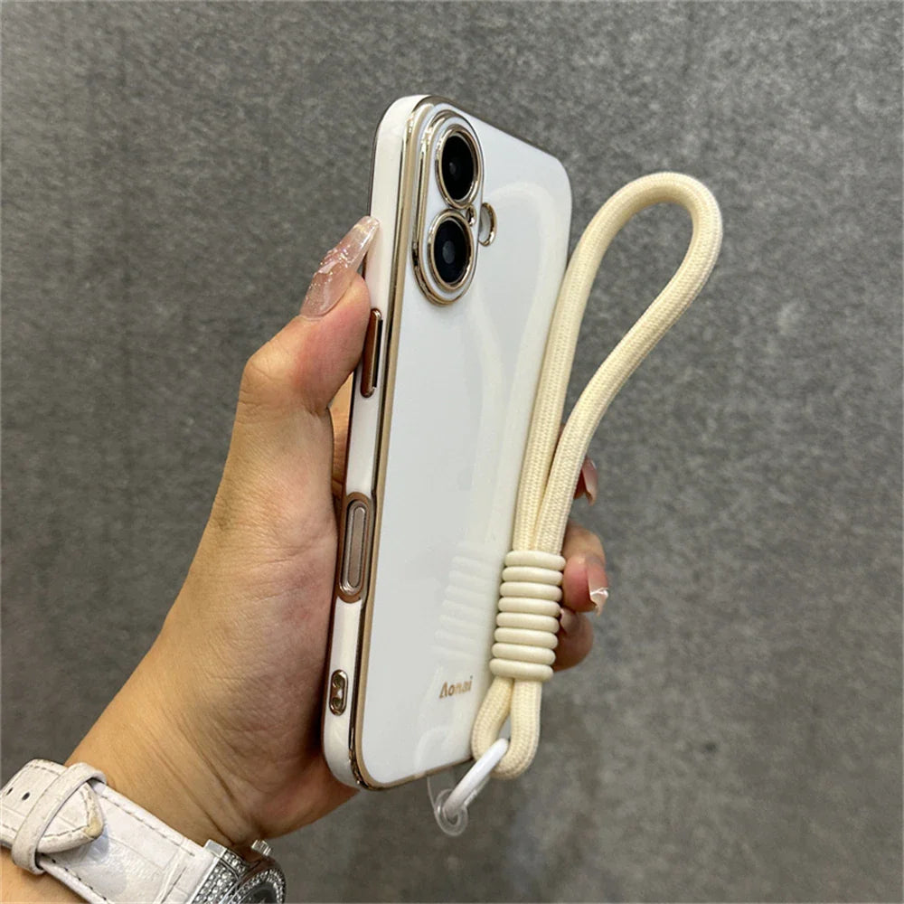 White and gold phone case with wrist strap.
