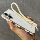 White and gold phone case with wrist strap.