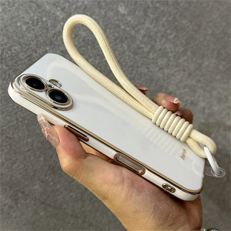 White and gold phone case with wrist strap.