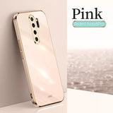 the back of a gold iphone with a white background