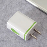 a white and green usb charger on a gray surface