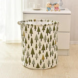 a small white and green tree print laundry basket