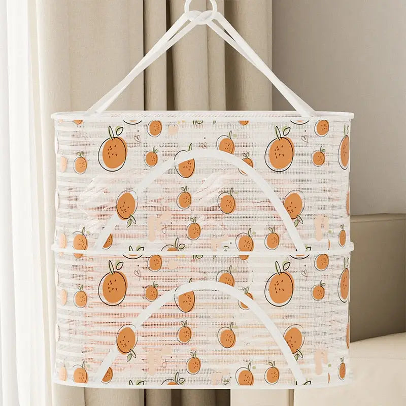 a white bag with oranges on it hanging from a curtain