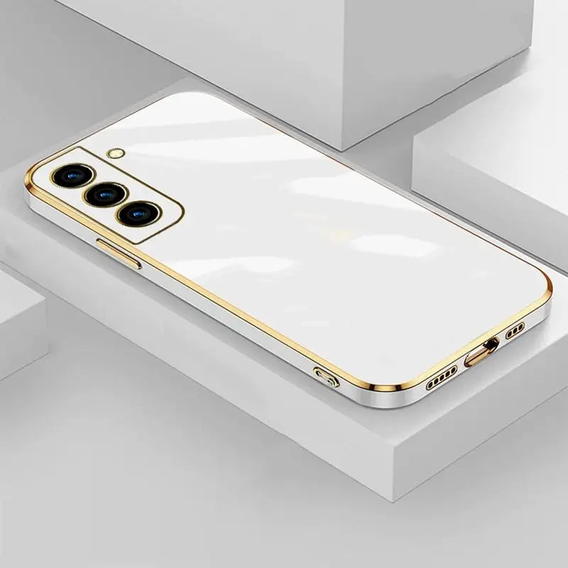 a white iphone case with gold trim