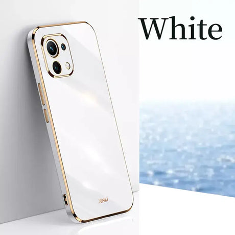 A white iphone case with a gold rim